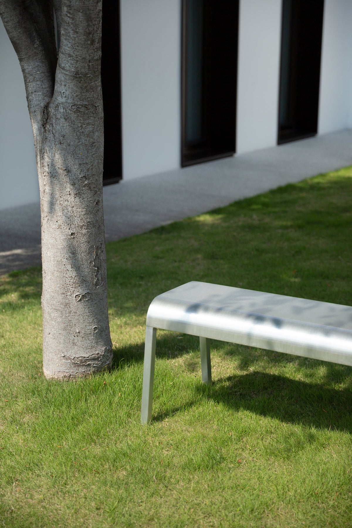 Emeco ZaZa aluminium bench in a garden