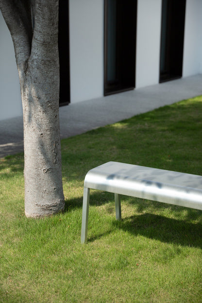 Emeco ZaZa aluminium bench in a garden