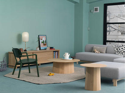 Sillón bajo Castor verde en un salón verde agua, con aparador y mesa baja redonda | Antifer