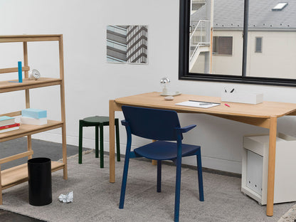 Hocker Castor Plus in Grün neben einem Schreibtisch aus Eiche, mit blauem Stuhl und Regal | Antifer