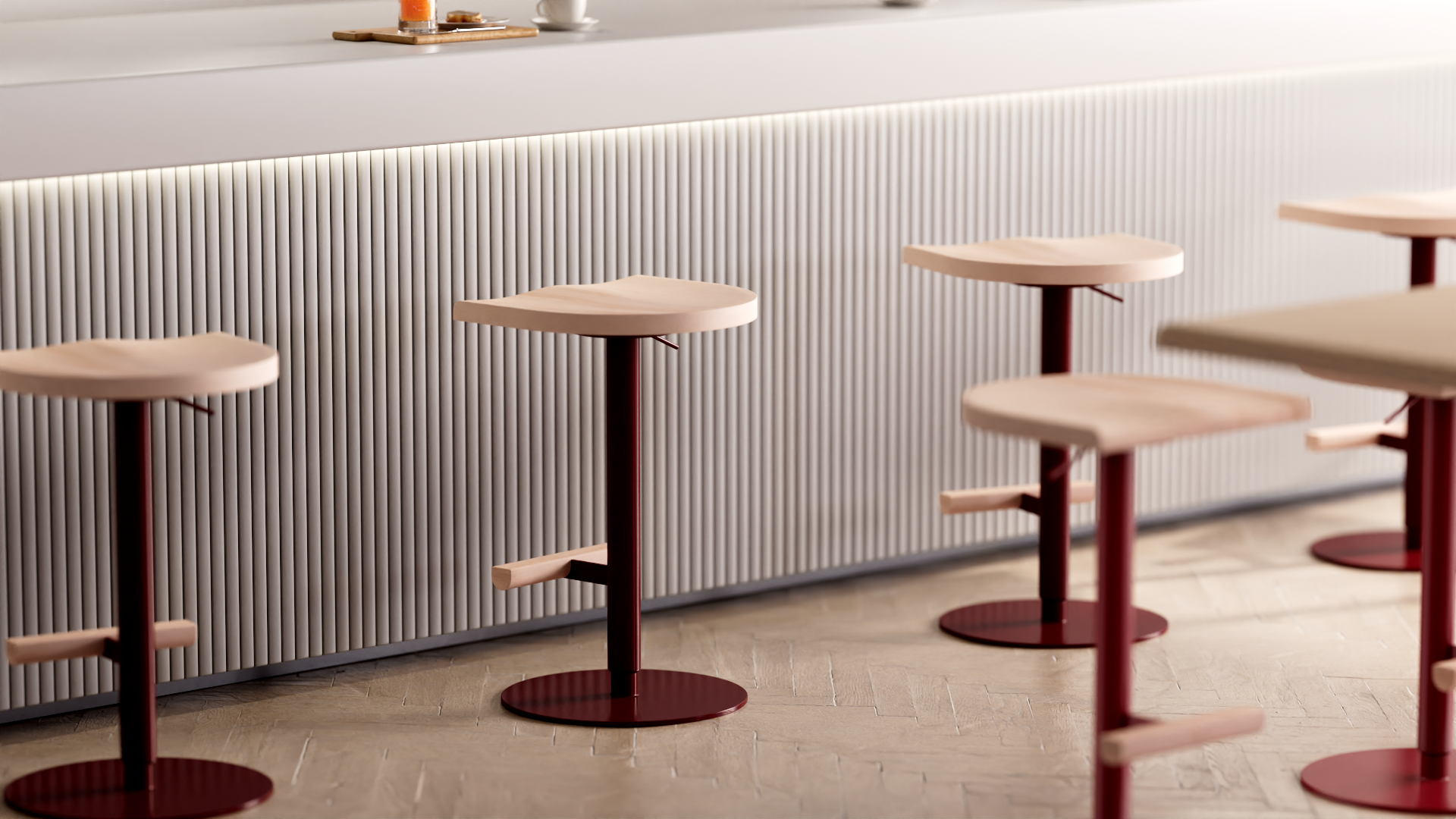 Tabouret ajustable Camarade en hêtre et acier devant un bar