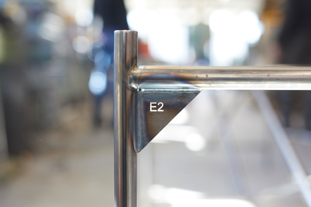 E2 steel table legs assembly and finish detail — minimalist design | Antifer