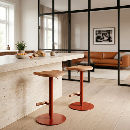 Adjustable Camarade stool in front of steel-framed glass partition and sofa — solid beech and steel, Big-Game | Antifer