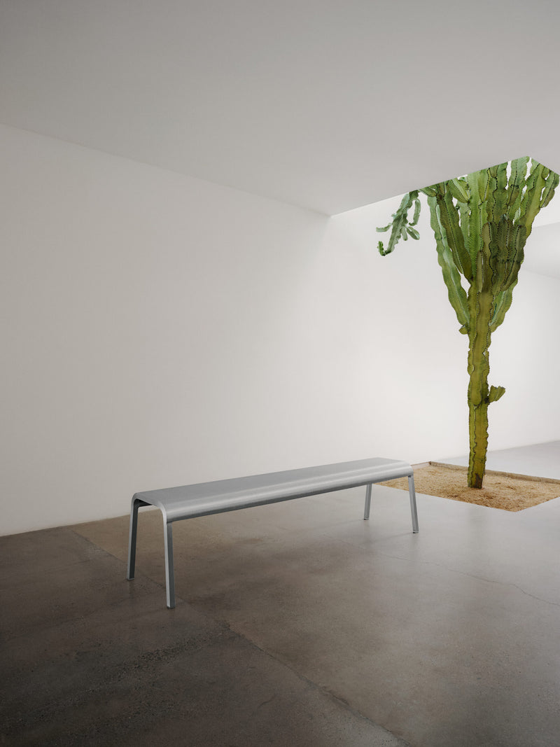 Emeco ZaZa bench in a gallery with a cactus