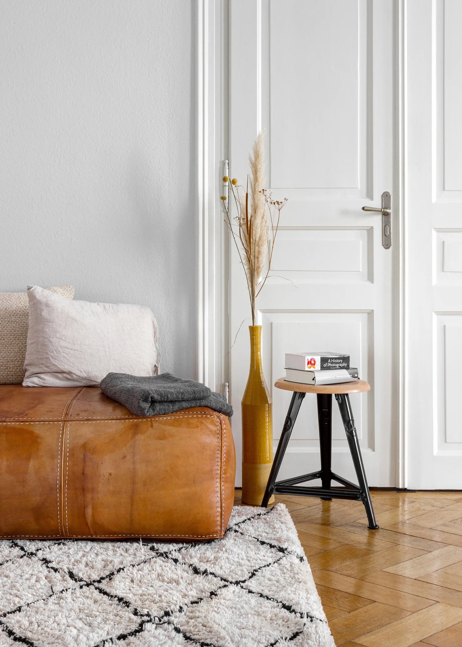 Detail of Rowac Schemel stool in a loft interior - combination of wood and cast iron, timeless industrial design