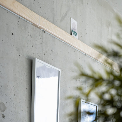 Variand V03 picture rail in situ — birch with hanging artwork — Variand design | Antifer